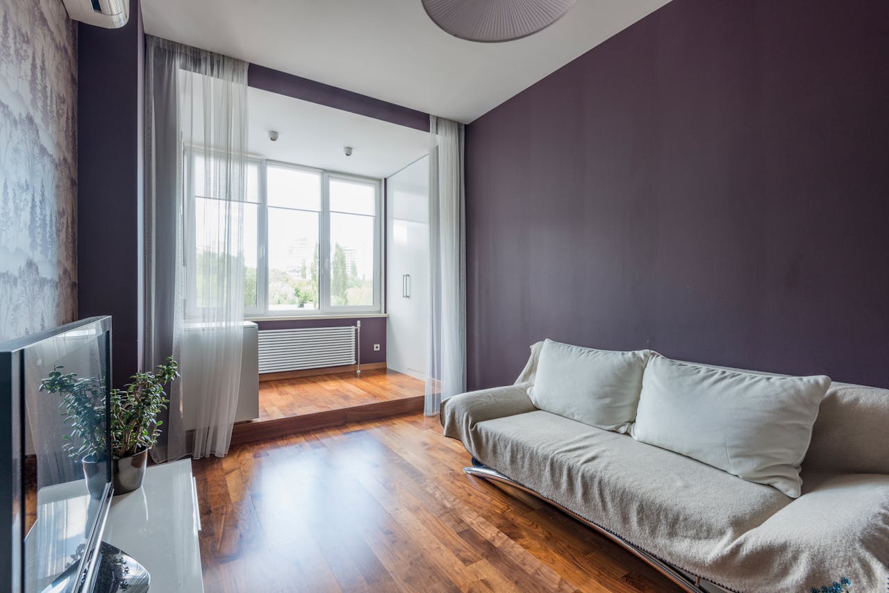 Stylishly designed living room with a cozy sofa and wooden floor.