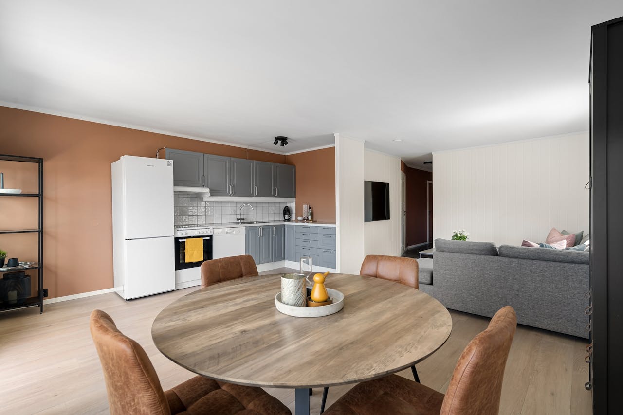 A contemporary open-plan kitchen and dining area with modern minimalist design elements in a stylish apartment.